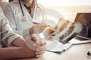 Doctor pointing to the x-ray sheet and describe a viral disease