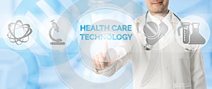 Doctor Points at HEALTH CARE TECHNOLOGY and Icons