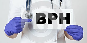 The doctor points his finger at a sign that says - BPH. Benign prostatic hyperplasia