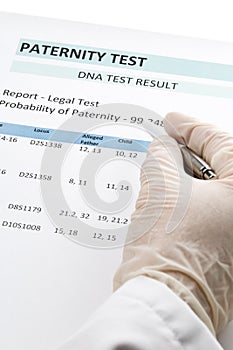 Doctor points at result on paternity test result form photo