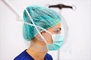 Doctor portrait with protective mask and hat in operating room