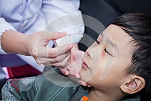 Doctor pouring eye drops in eye patient