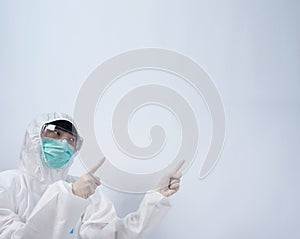 Doctor in PPE suit or Personal Protection Equipment point out to copy space