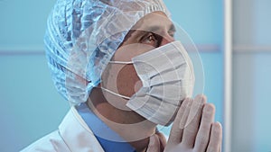 Doctor praying in hospital