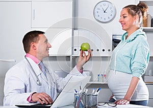 Doctor and pregnant visitor