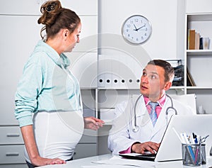 Doctor and pregnant visitor