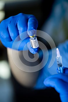 Doctor preparing injection with covid-19 vaccine at hospital