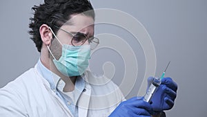 Doctor preparing syringe with medicine for injection