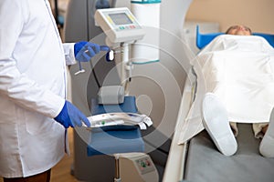 Doctor preparing venflon catheter during CT scan test