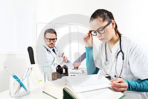 Doctor prescribes prescription with the tablet and nurse read photo