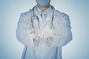 Doctor presenting blank palm of hand holding something copy space