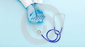 Doctor presenting empty hands, blank palm and stethoscope on blue color background. Doctor or nurse holding virtual object mockup