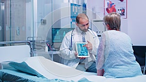 Doctor presenting X Ray scan on digital tablet