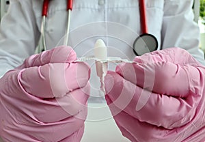 Doctor proctologist holding in hands antiinflammatory suppository for hemorrhoids closeup photo