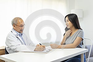 Doctor in professional uniform examining young patient woman at hospital or medical clinic. Health care