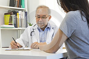 Doctor in professional uniform examining young patient woman at hospital or medical clinic. Health care