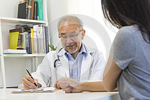 Doctor in professional uniform examining young patient woman at hospital or medical clinic. Health care