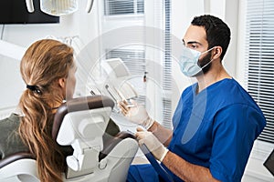 Doctor with protection mask telling something to his client