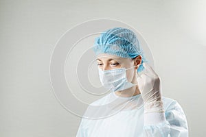 Doctor with protective clothing and face mask in clinic at Covid-19 coronavirus epidemic