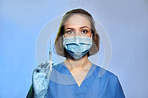 Doctor in protective mask and blue latex gloves with syringe with a medicine vaccine from Coronavirus