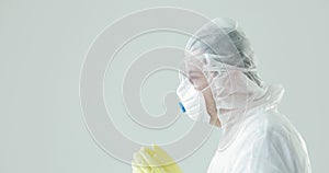 Doctor in protective suit, mask, glasses coughing, coronavirus pandemic threat.