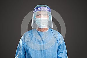 Doctor in protective uniform and face shield