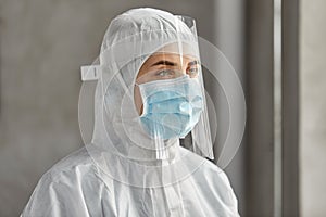 Doctor in protective wear, mask and face shield