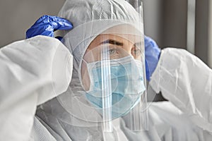 Doctor in protective wear, mask and face shield