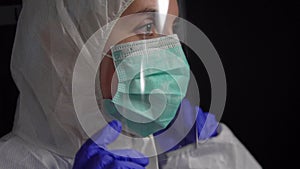 Doctor in protective wear, medical mask and gloves