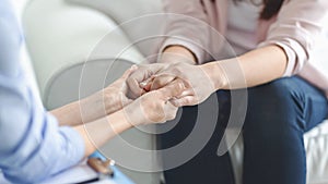 Doctor, psychologist, therapist holding female patient hands