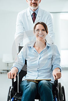 Doctor pushing a patient in wheelchair