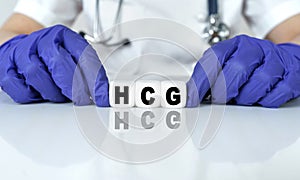 The doctor put together a word from cubes HCG. Human Chorionic Gonadotropin