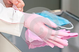 Doctor puts on latex gloves