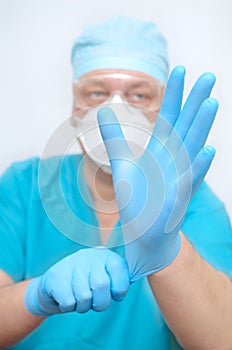 The doctor puts on sterile gloves. Preparing for surgery