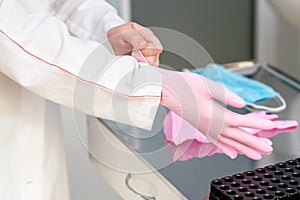 Doctor putting on latex gloves