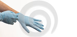 Doctor putting on medical gloves isolated on white background
