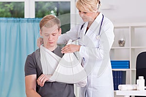 Doctor putting on sling