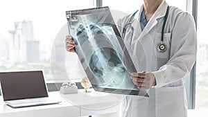 Doctor with radiological chest x-ray film for medical diagnosis on patientâ€™s health on asthma lung disease