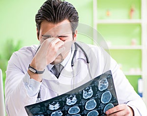 Doctor radiologist looking at x-ray scan in hospital