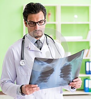 Doctor radiologist looking at x-ray scan in hospital