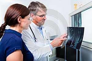 Doctor with x-ray picture of patient hand