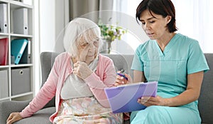 Doctor Reads Elderly Woman Health Documents