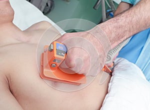 Doctor reanimates patient by an electrical defibrillator