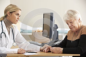 Doctor reassuring senior woman patient