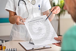 Doctor receiving patient registration form