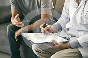 Doctor is recording the patient`s information while the patient is explaining