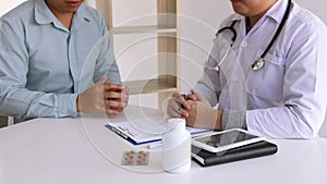 Doctor is recording the patient`s information while the patient is explaining