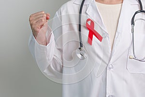 Doctor with Red Ribbon for December World Aids Day, acquired immune deficiency syndrome, multiple myeloma Cancer Awareness month