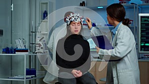 Doctor researcher adjusting EEG headset analyzing patient's evolution