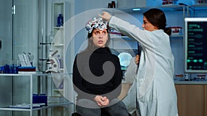 Doctor researcher adjusting EEG headset analyzing patient& x27;s evolution